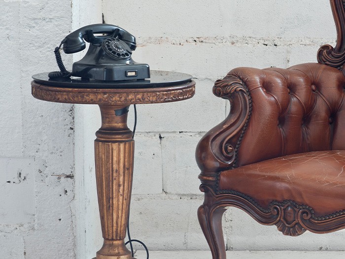 Old phone on a side table.